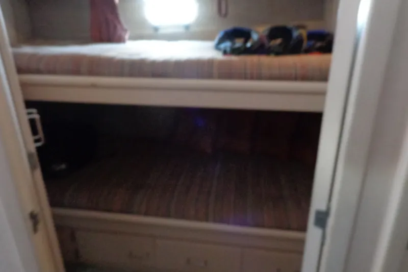 Slide: The Image of Interior of 1989 Tollycraft 34 Sport Sedan with bunk beds and window. - 21