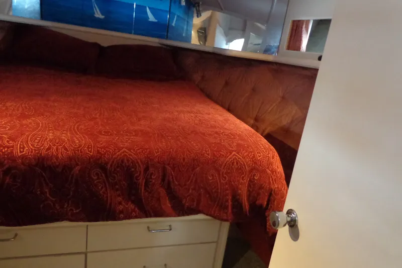 Slide: The Image of Interior cabin of 1989 Tollycraft 34 Sport Sedan with red bedding. - 20