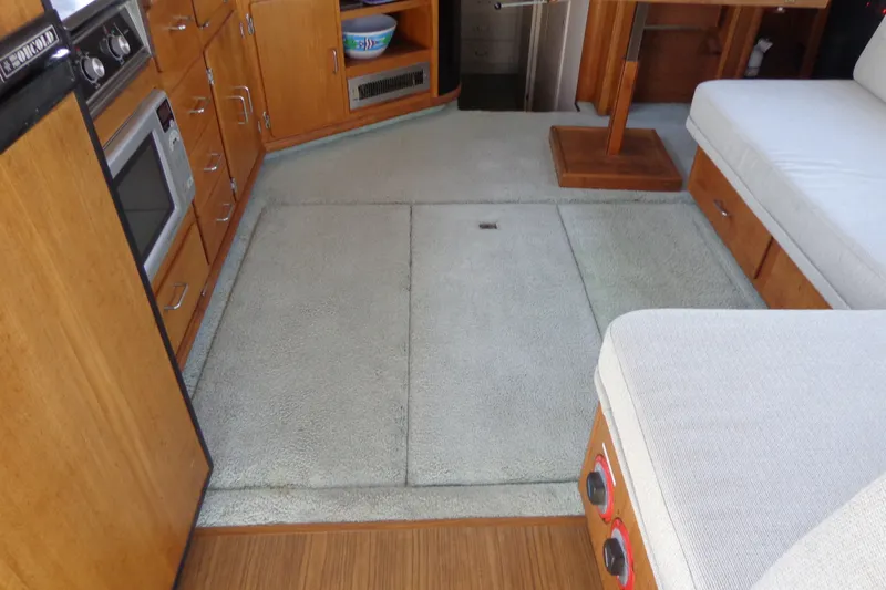 Slide: The Image of Interior of 1989 Tollycraft 34 Sport Sedan with kitchen and seating area. - 44