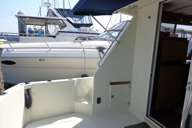 Slide: The Image of 1989 Tollycraft 34 Sport Sedan yacht interior with open door and docked boats. - 57