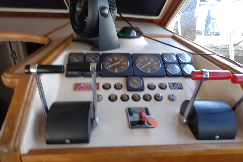Slide: The Image of 1989 Tollycraft 34 Sport Sedan helm with controls and gauges. - 36