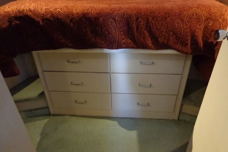 Slide: The Image of Interior of 1989 Tollycraft 34 Sport Sedan with drawers under a bed. - 22