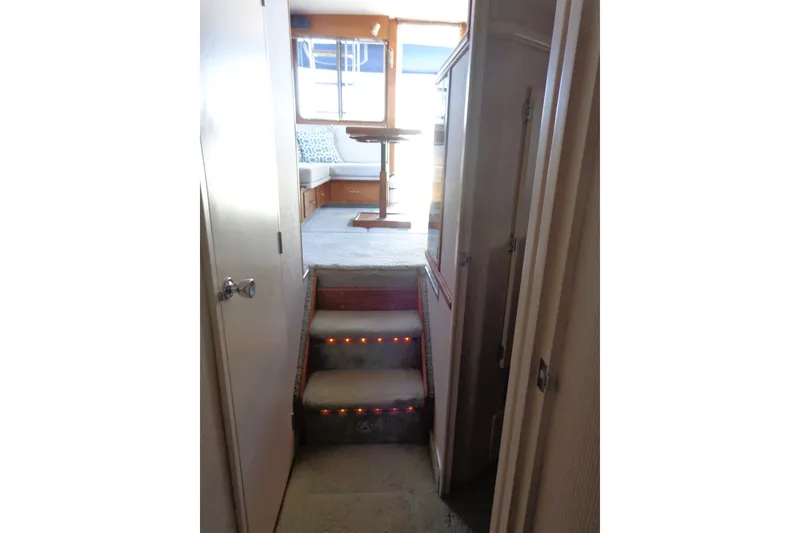 Slide: The Image of Interior view of 1989 Tollycraft 34 Sport Sedan with carpeted stairs and seating area. - 31