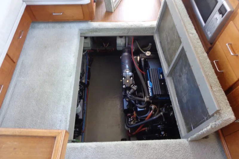 Slide: The Image of Engine compartment of a 1989 Tollycraft 34 Sport Sedan, showcasing the engine and interior layout. - 41