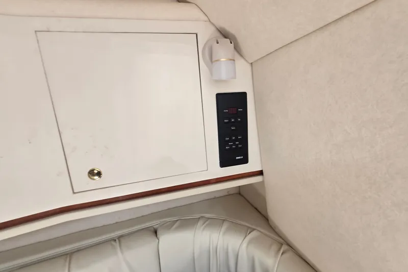 Slide: The Image of Interior of 2000 Sea Ray 290 Amberjack with control panel and storage cabinet. - 19