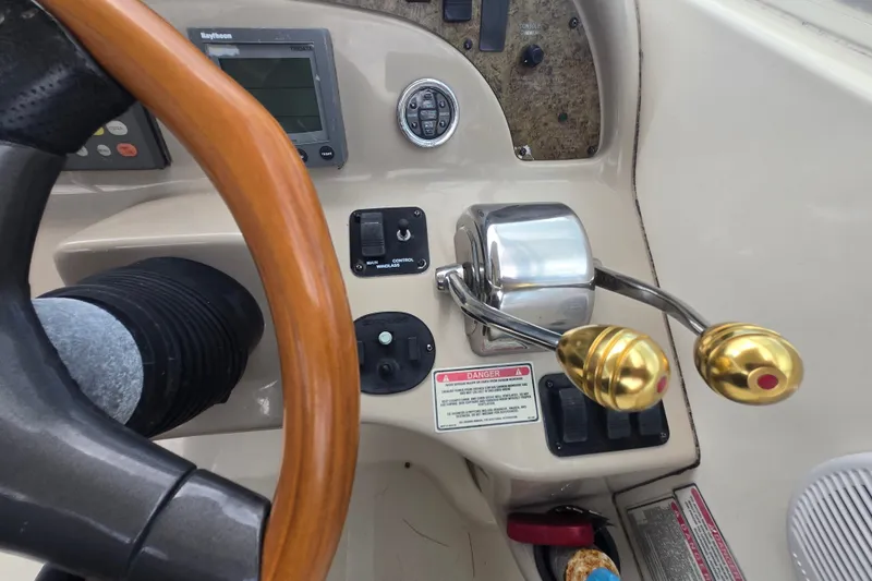 Slide: The Image of Steering wheel and controls of a 2000 Sea Ray 290 Amberjack boat. - 20