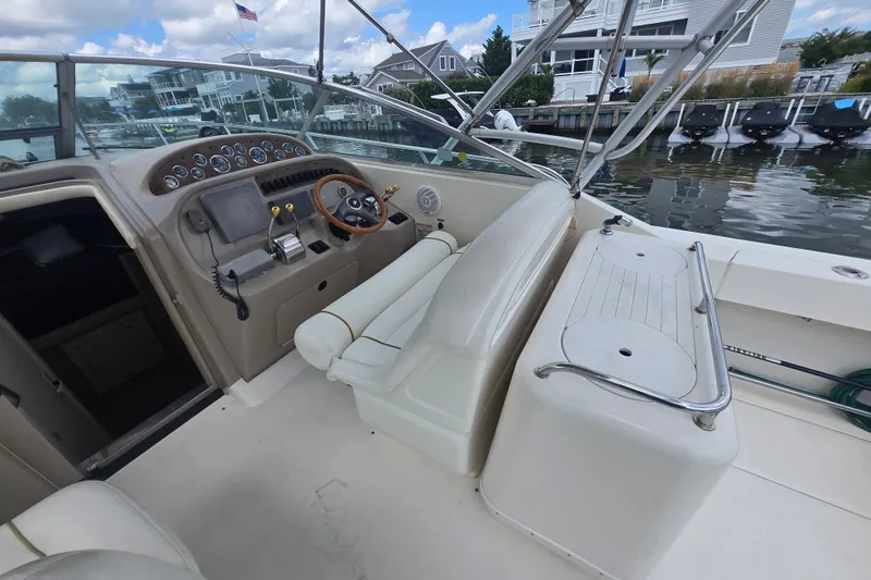 Slide: The Image of 2000 Sea Ray 290 Amberjack boat interior with steering wheel and control panel. - 11