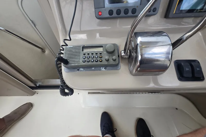 Slide: The Image of Control panel of a 2000 Sea Ray 290 Amberjack boat with radio and throttle. - 22