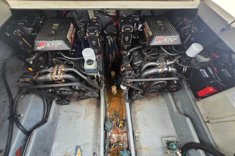 Slide: The Image of Engine compartment of a 2000 Sea Ray 290 Amberjack with twin 5.7L Mercury engines. - 26