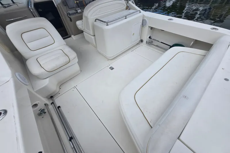 Slide: The Image of 2000 Sea Ray 290 Amberjack boat interior with white seating and spacious deck area. - 7