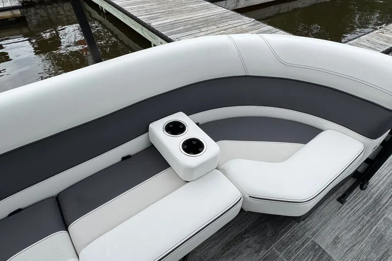 Slide: The Image of Luxurious seating on 2026 Viaggio Diamante S 26 boat with cup holders, dockside view. - 29