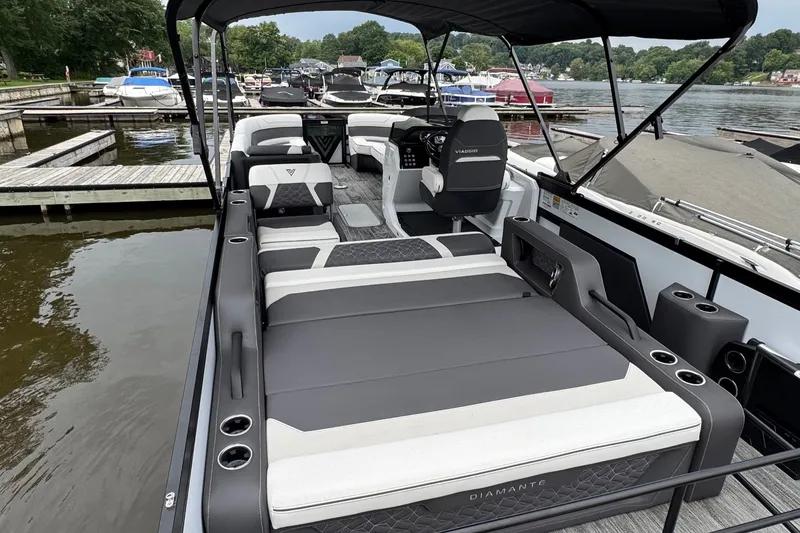 Slide: The Image of 2026 Viaggio Diamante S 26 luxury pontoon boat with spacious seating at a marina. - 22