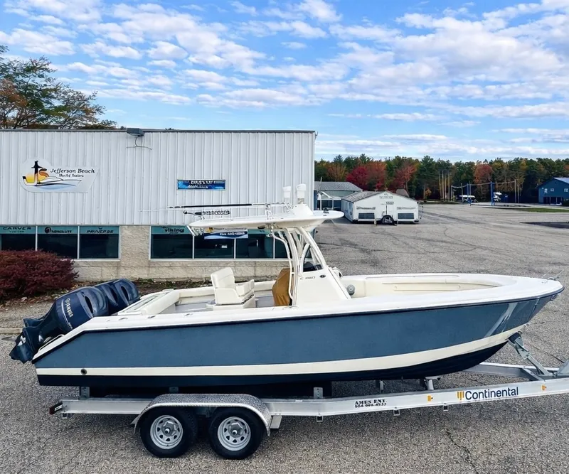 Slide: The Image of A 2017 Pursuit C 260 Center Console boat on a trailer in front of a building. - 18