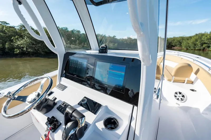Slide: The Image of Manufacturer Provided Image: 2025 Sportsman Open 252 Center Console boat interior with modern dashboard and steering wheel. - 8