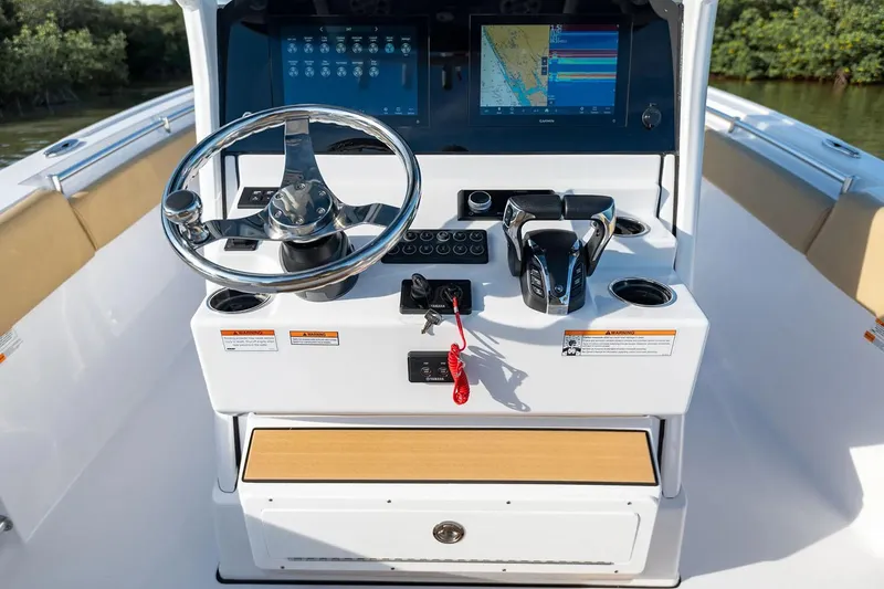 Slide: The Image of Manufacturer Provided Image: 2025 Sportsman Open 252 Center Console dashboard with steering wheel and navigation screens. - 7