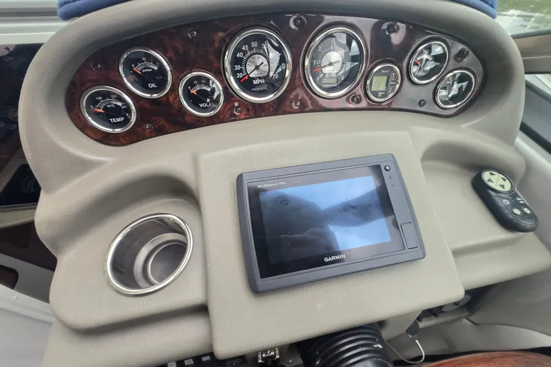 Slide: The Image of Dashboard of a 2014 Crownline 264 CR boat with gauges and Garmin device. - 17