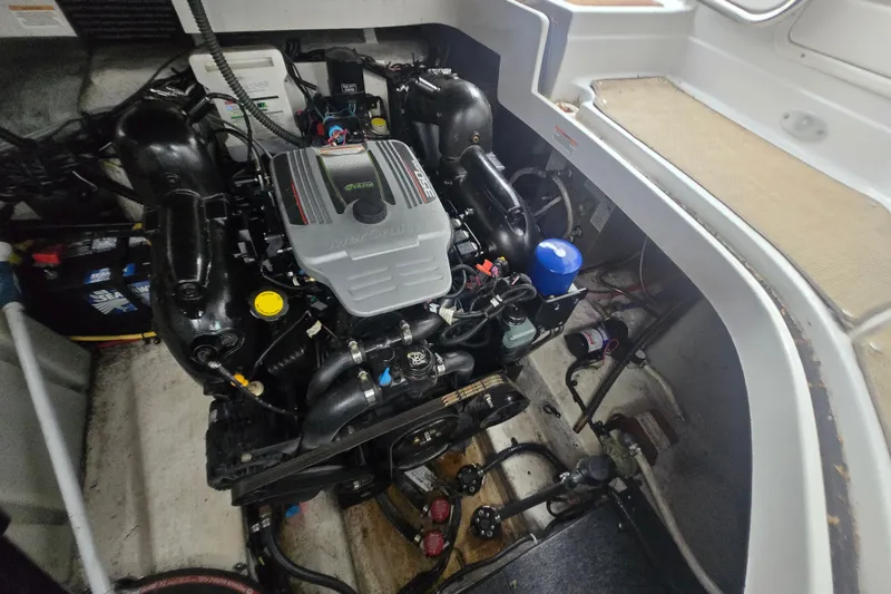 Slide: The Image of Engine compartment of a 2014 Crownline 264 CR boat, showcasing detailed mechanical components. - 7