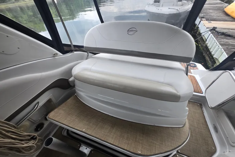 Slide: The Image of Interior of a 2014 Crownline 264 CR boat with white seating and lake view. - 26