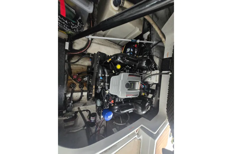 Slide: The Image of Engine compartment of a 2014 Crownline 264 CR boat, showcasing detailed mechanics. - 29