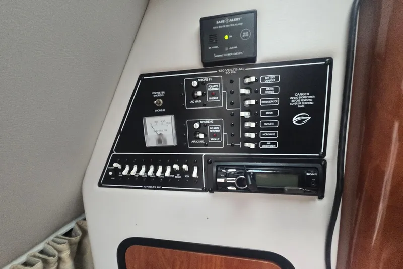 Slide: The Image of Control panel of a 2014 Crownline 264 CR boat, featuring electrical switches and a Sony stereo. - 21