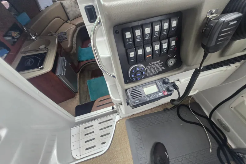 Slide: The Image of 2014 Crownline 264 CR boat interior with control panel and cabin view. - 19