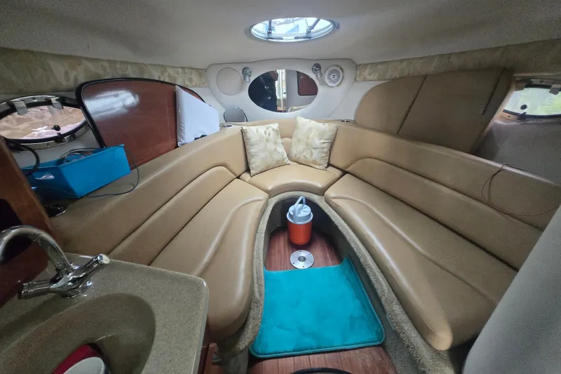 Slide: The Image of Interior of 2014 Crownline 264 CR boat with beige seating and modern amenities. - 24