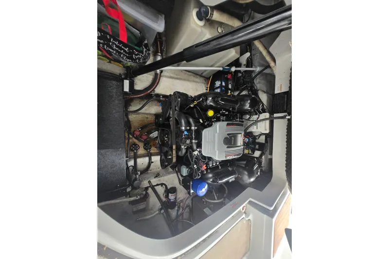 Slide: The Image of Engine compartment of a 2014 Crownline 264 CR boat, showcasing detailed mechanical components. - 28