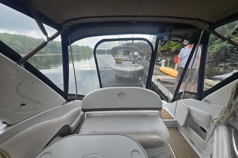 Slide: The Image of Interior view of 2014 Crownline 264 CR boat docked by a serene lake. - 5
