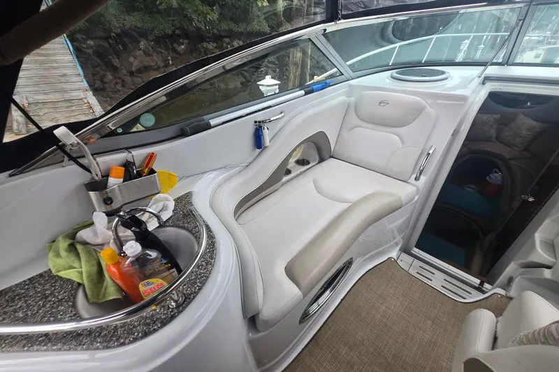 Slide: The Image of Interior of 2014 Crownline 264 CR boat with seating and sink area. - 11