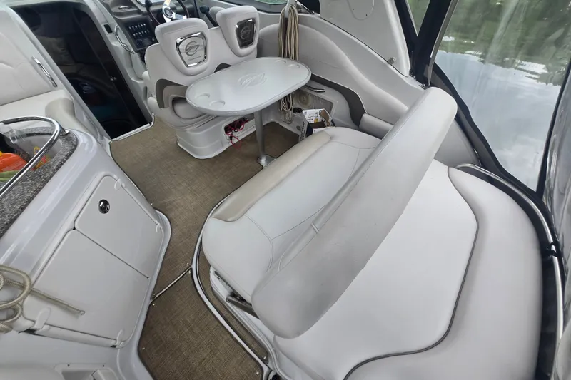 Slide: The Image of Interior of a 2014 Crownline 264 CR boat with seating and table setup. - 6