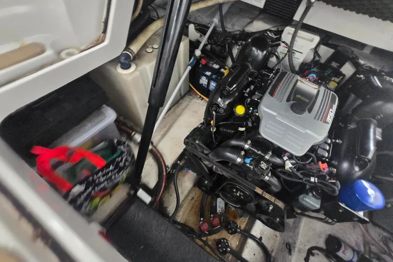 Slide: The Image of Engine compartment of a 2014 Crownline 264 CR boat, showcasing mechanical components. - 27
