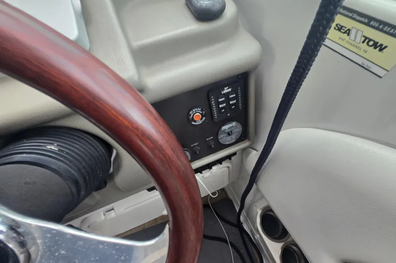 Slide: The Image of 2014 Crownline 264 CR boat dashboard with steering wheel and control panel. - 18