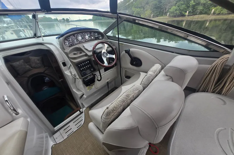 Slide: The Image of 2014 Crownline 264 CR boat interior with helm, steering wheel, and cabin entrance. - 12