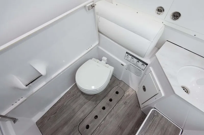 Slide: The Image of Manufacturer Provided Image: 2025 Sportsman Open 322 Center Console boat bathroom with modern fixtures and wood-style flooring. - 22