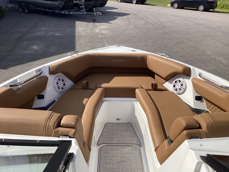 Slide: The Image of The image shows the bow of a Cobalt R26 boat with brown upholstery and speakers. - 16