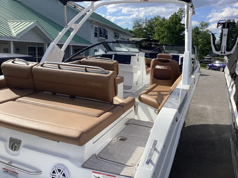 Slide: The Image of A sleek Cobalt R26 boat with brown leather seats, parked in a sunny setting. - 10