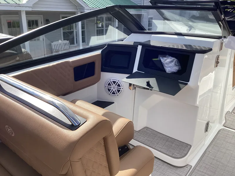 Slide: The Image of The image shows the cockpit of a 2027 Cobalt R26 boat with beige leather seats and modern instruments. - 13