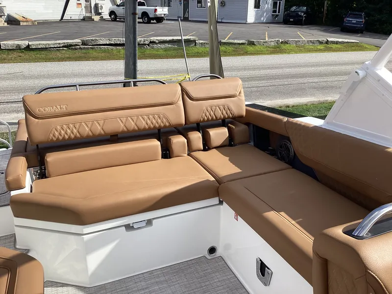 Slide: The Image of The image shows the seating area of a Cobalt R26 boat with brown upholstery. - 11