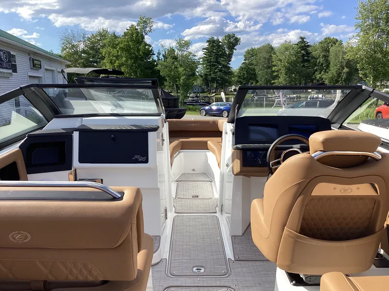 Slide: The Image of The image shows the cockpit of a 2027 Cobalt R26 boat with brown leather seats and modern instruments. - 18