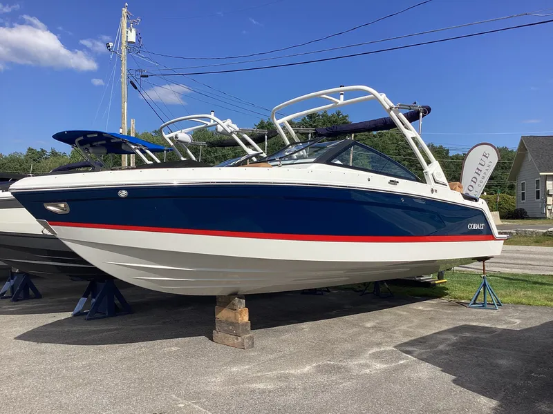 Slide: The Image of A 2027 Cobalt R26 boat is parked on a lot. It features a blue hull with white accents. - 3