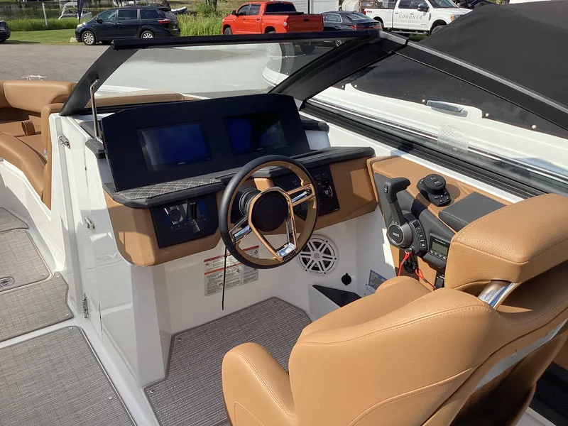Slide: The Image of The image shows the cockpit of a Cobalt R26 boat with a modern steering wheel and dashboard. - 15