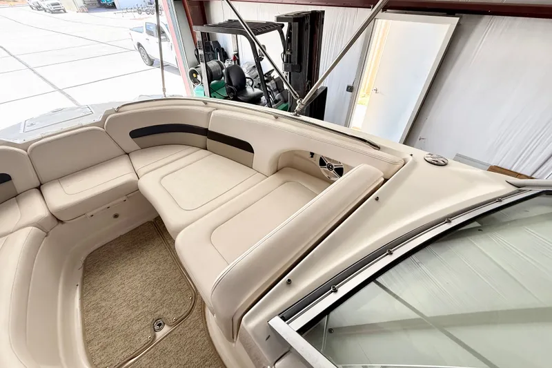Slide: The Image of 2008 Chaparral Sunesta 284 boat interior with beige seating and carpeted floor. - 30