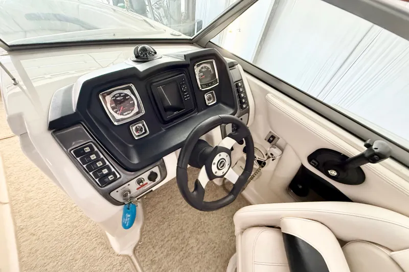 Slide: The Image of 2008 Chaparral Sunesta 284 boat dashboard with steering wheel and control panel. - 19