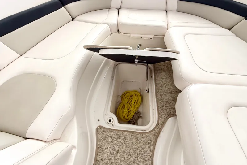 Slide: The Image of 2008 Chaparral Sunesta 284 boat interior with open storage compartment and yellow rope. - 33
