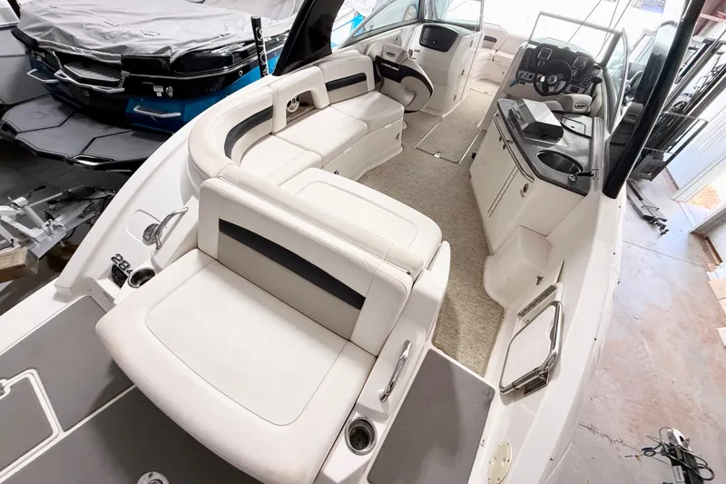 Slide: The Image of 2008 Chaparral Sunesta 284 boat interior with seating, helm, and kitchenette. - 27