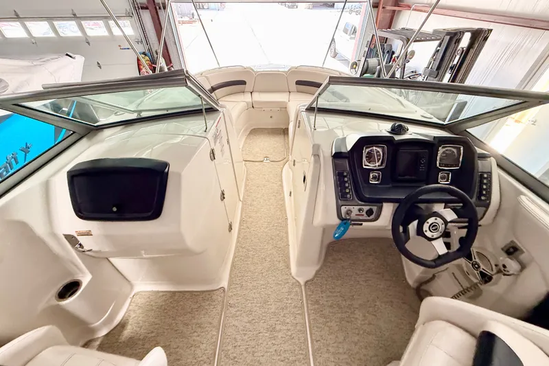 Slide: The Image of 2008 Chaparral Sunesta 284 boat interior with steering wheel and seating area. - 18
