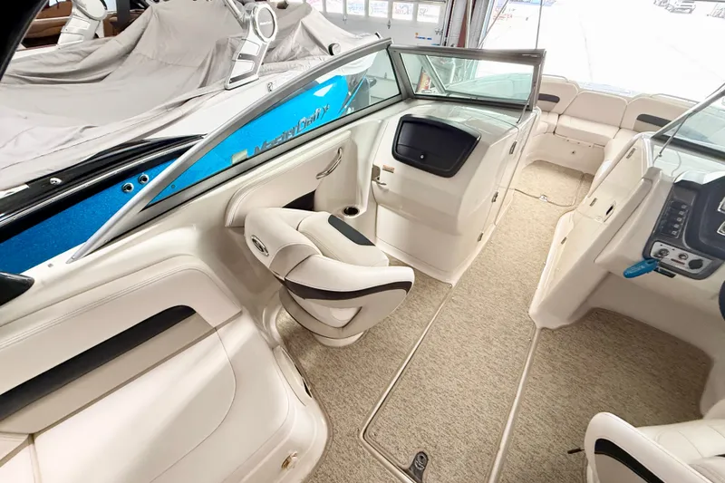 Slide: The Image of Interior of a 2008 Chaparral Sunesta 284 boat, featuring plush seating and modern controls. - 17