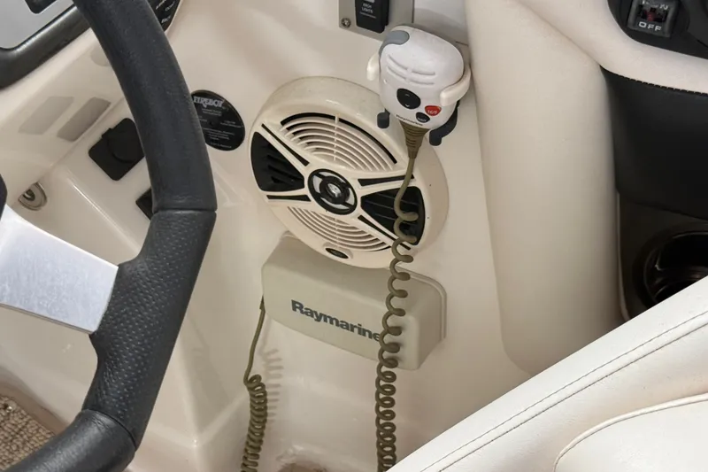 Slide: The Image of 2008 Chaparral Sunesta 284 boat dashboard with steering wheel, speaker, and Raymarine equipment. - 36