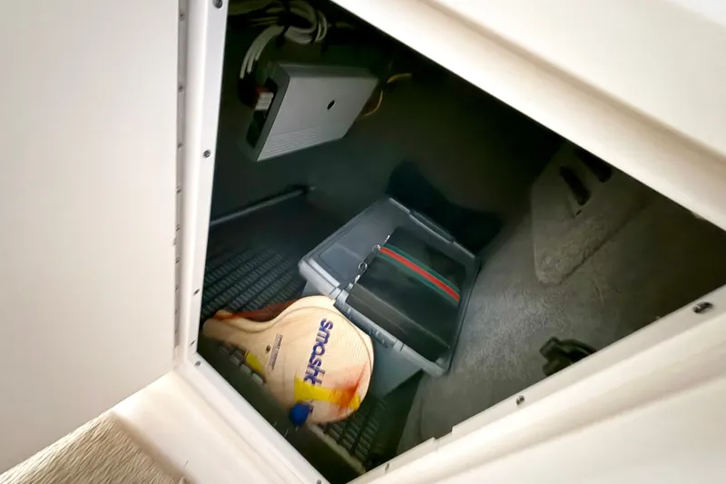 Slide: The Image of Storage compartment in 2008 Chaparral Sunesta 284 boat with paddles and equipment. - 35