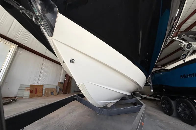 Slide: The Image of 2008 Chaparral Sunesta 284 boat in storage, showcasing sleek hull design. - 25